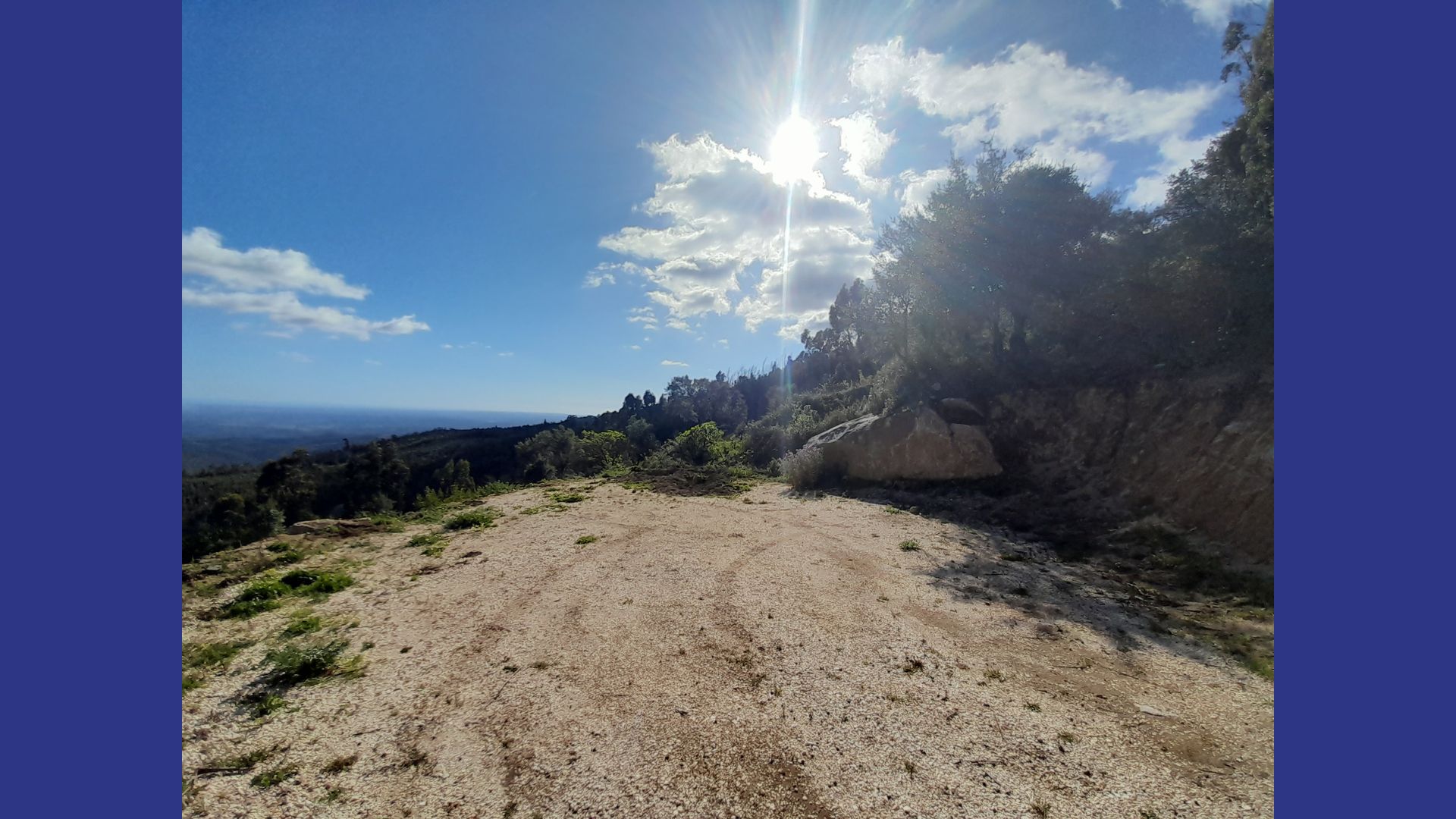 Open ridge with sun and sky above the land